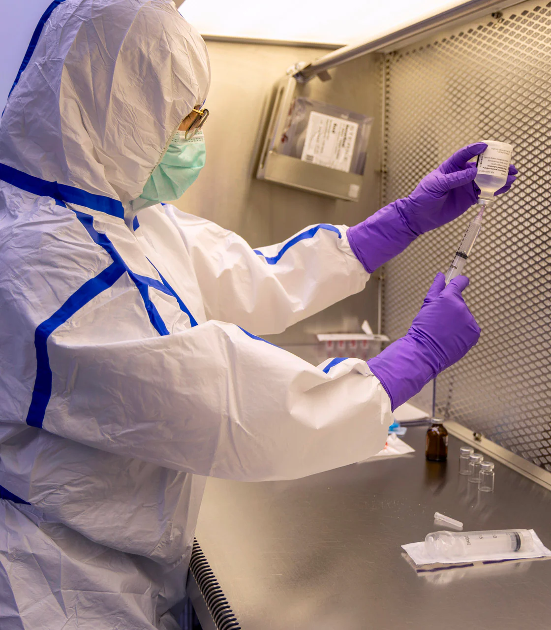 Town & Country Compounding pharmacist in sterile cleanroom gear preparing ophthalmic medication